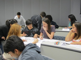Students prepare their group's answer for the Midterm Oral Exam.